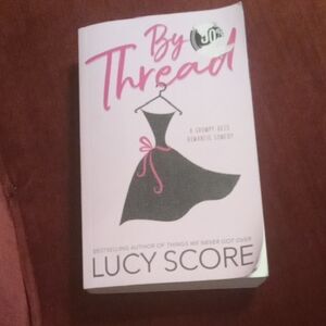 Pink and Black 'By a Thread' Book by Lucy Score
